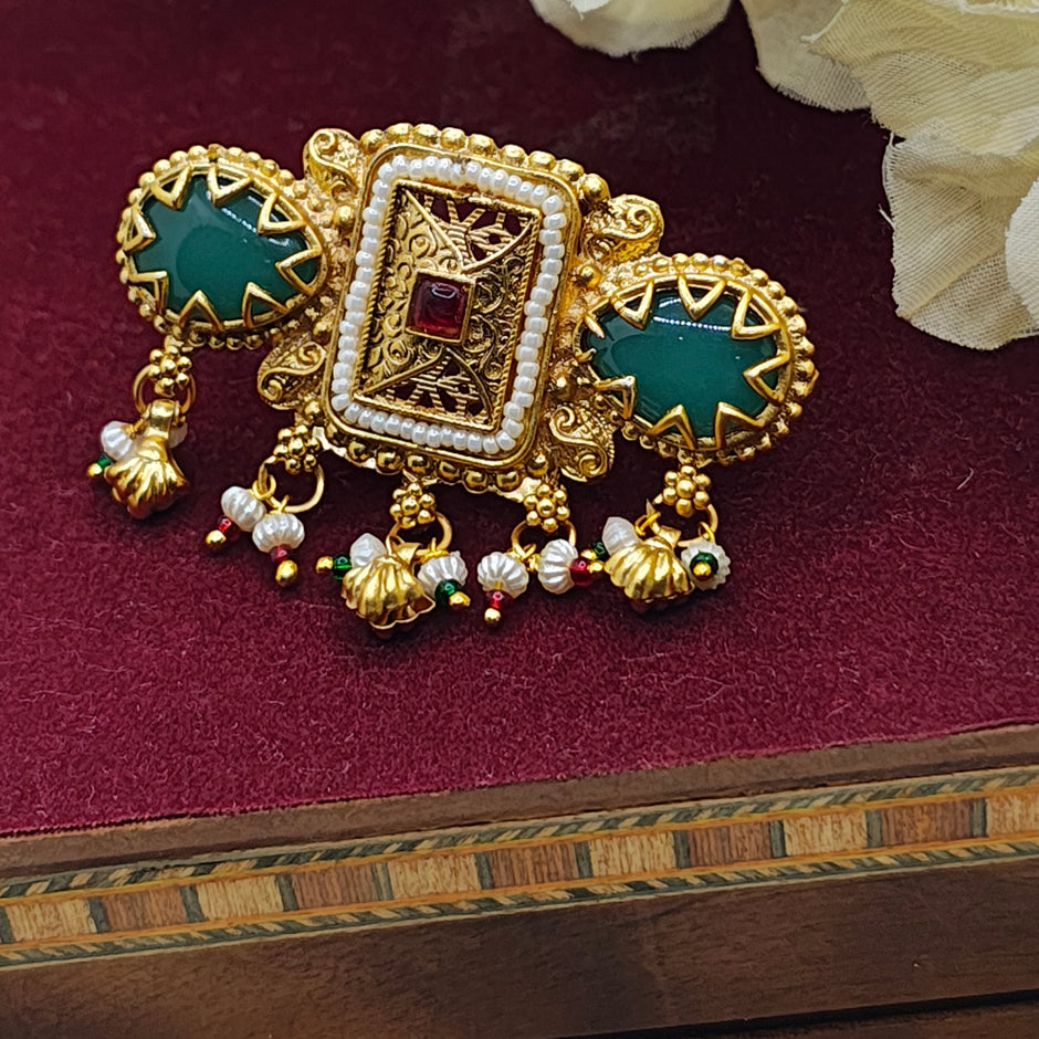 Rajasi Antique Gold Kundan Ring with green stone and pearl drops, showcasing intricate traditional Indian design.