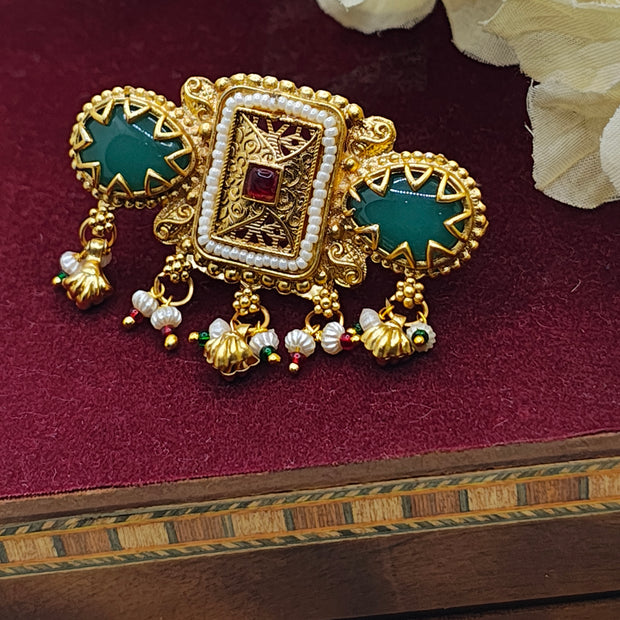 Rajasi Antique Gold Kundan Ring with green stone and pearl drops, showcasing intricate traditional Indian design.
